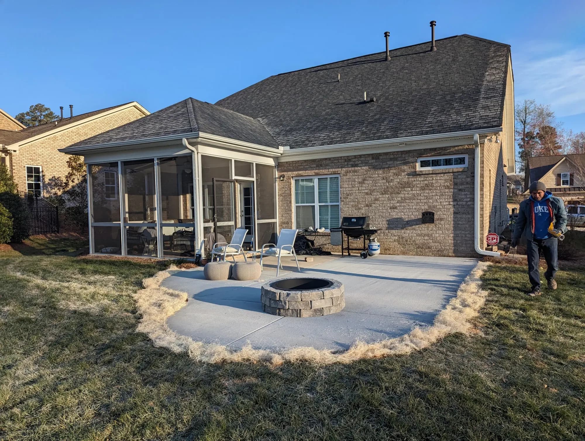 Completed broom-finished concrete patio with a fire-pit opening in Winston-Salem, NC